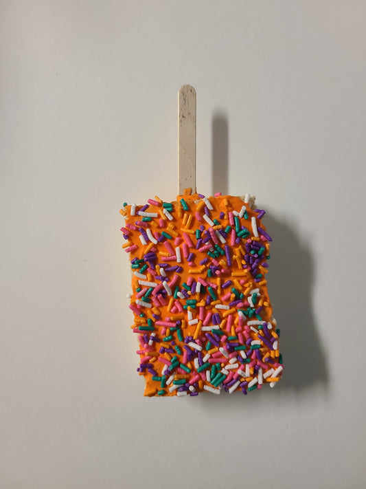 Rice crispy treat with royal icing on a stick